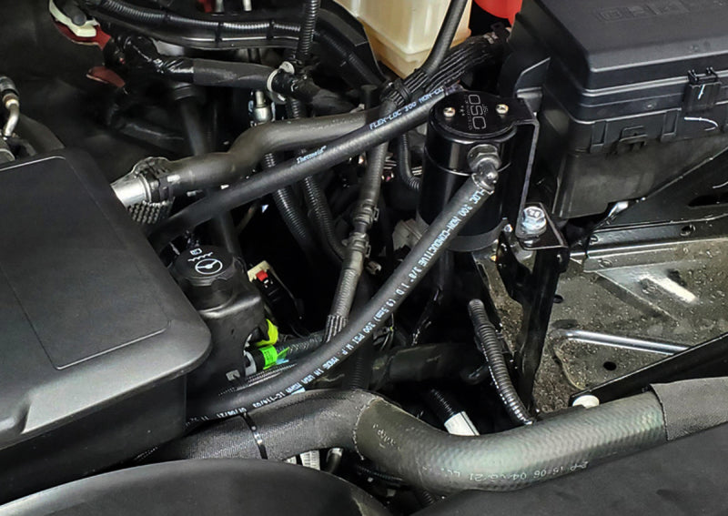 Load image into Gallery viewer, J&amp;L 20-26 Chevy Silverado/GMC Sierra 2500/3500 6.6L Drivers Side Oil Separator 3.0 - Black Anodi
