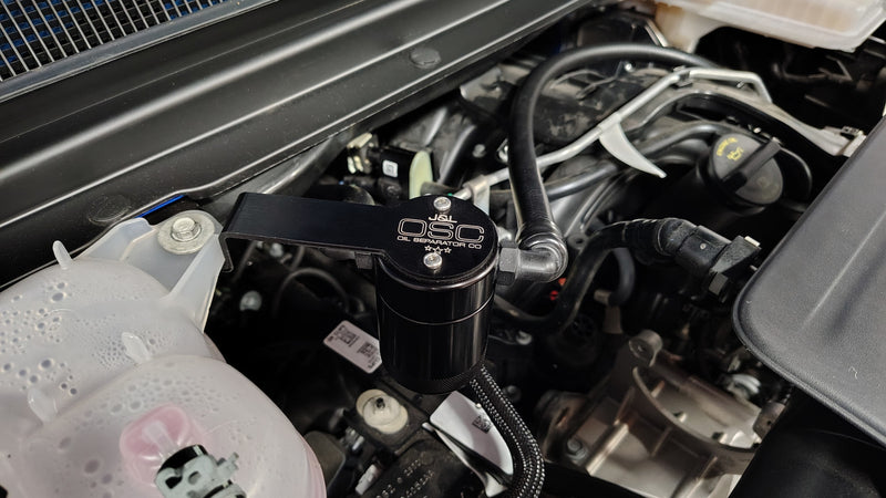 Load image into Gallery viewer, J&amp;L | 2019-2025 Dodge Ram 1500 3.6L New Body Style Oil Separator 3.0 PCV Side - Black Anodized
