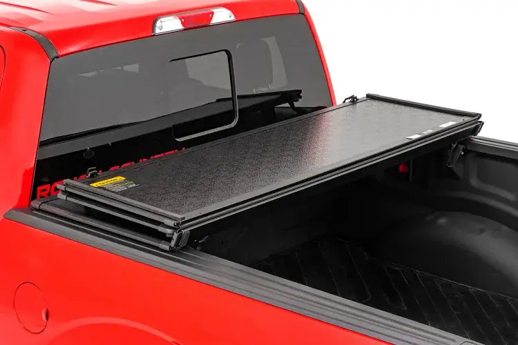 Load image into Gallery viewer, Rough Country | 2016-2023 Toyota Tacoma 5&#39; Hard Folding Bed Cover | 45716501A
